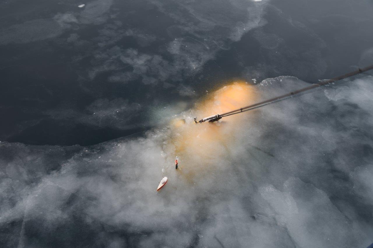A train on a track with smoke coming out of it.