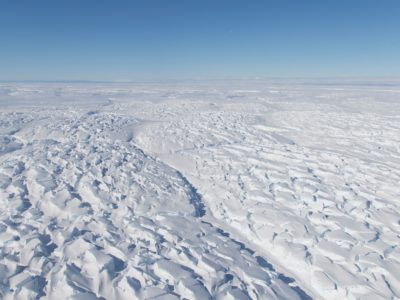 A close up of a snow covered slope.