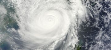 A large waterfall over a wave.