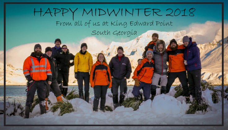 A group of people posing for a picture in the snow.