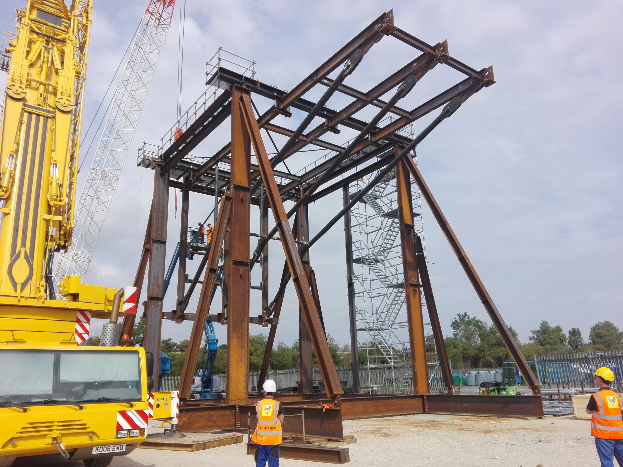A crane next to a bus.