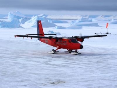 A airplane that is covered in snow.