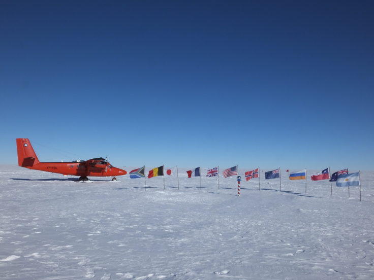 A group of people riding skis on top of a snow covered slope.