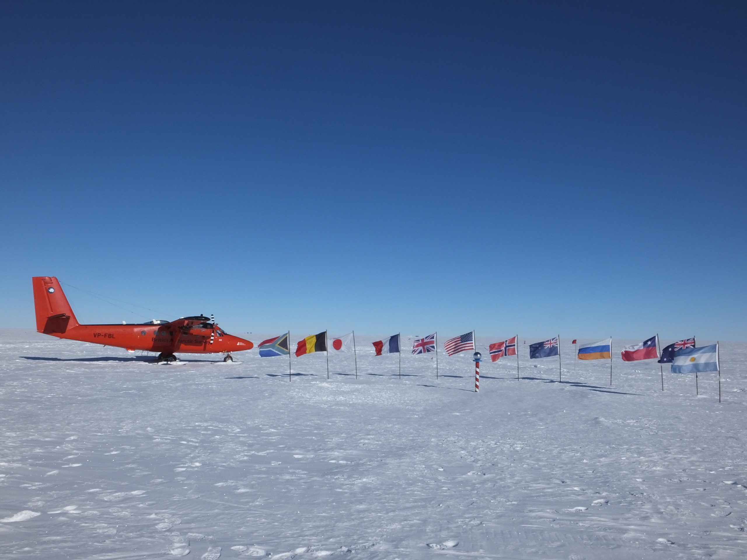 A group of people riding skis on top of a snow covered slope.