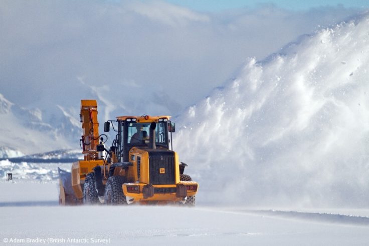 A truck is parked in the snow.