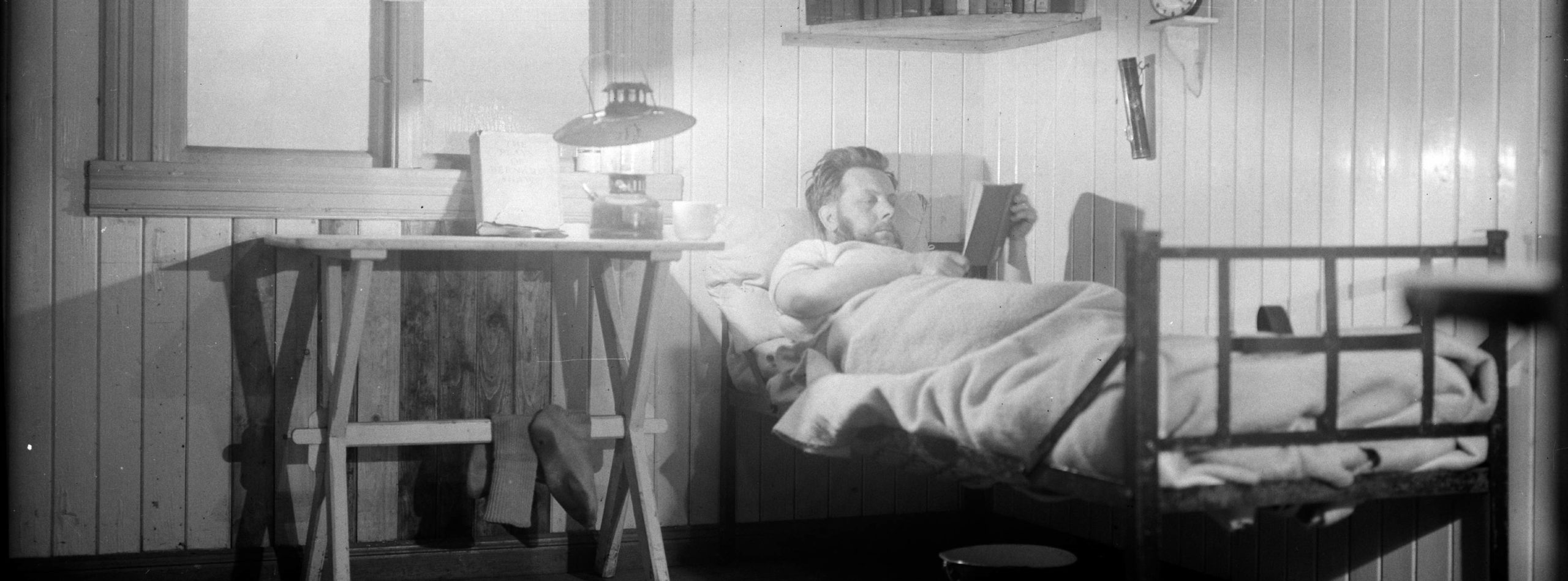 A man sitting on a chair in front of a mirror.