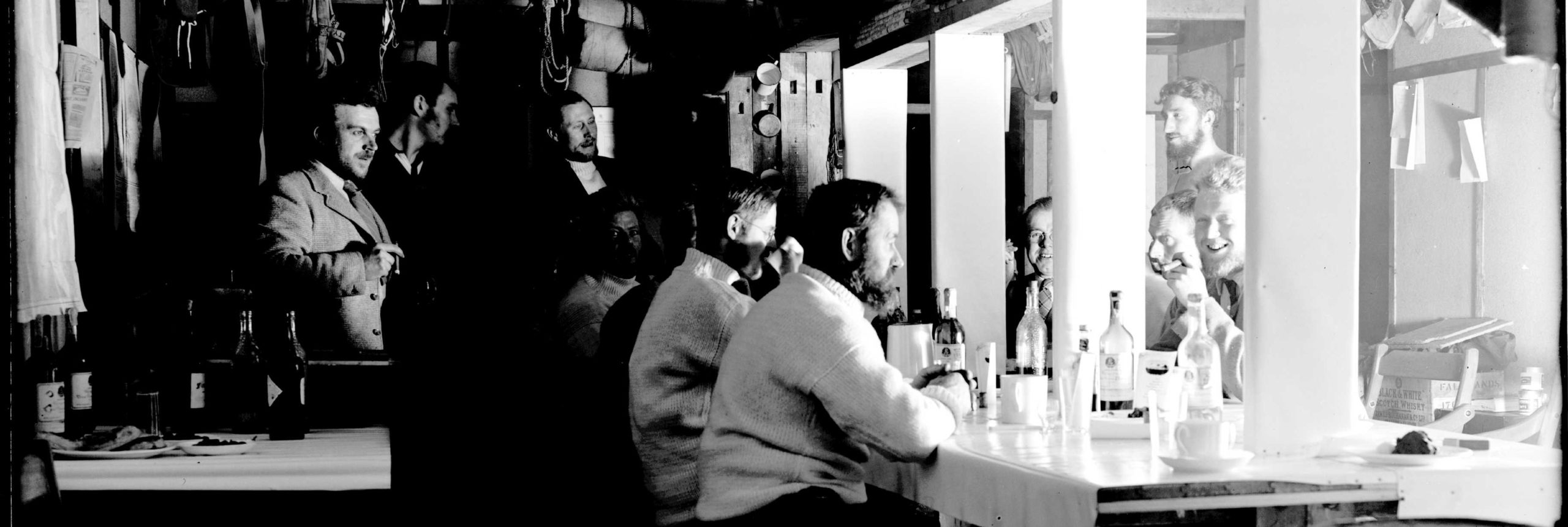 A group of people standing in front of a mirror posing for the camera.