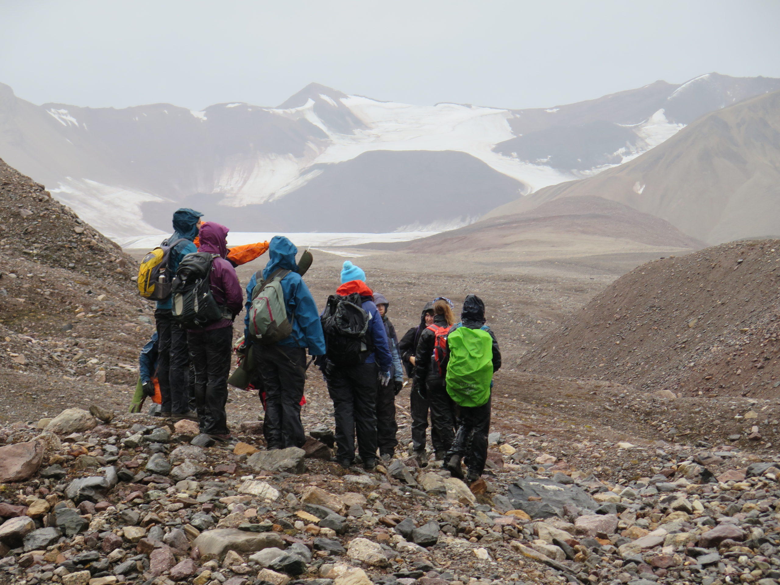A group of people standing on top of a mountain.
