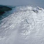 A close up of a snow covered mountain.