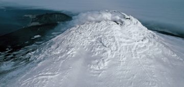 A close up of a snow covered mountain.