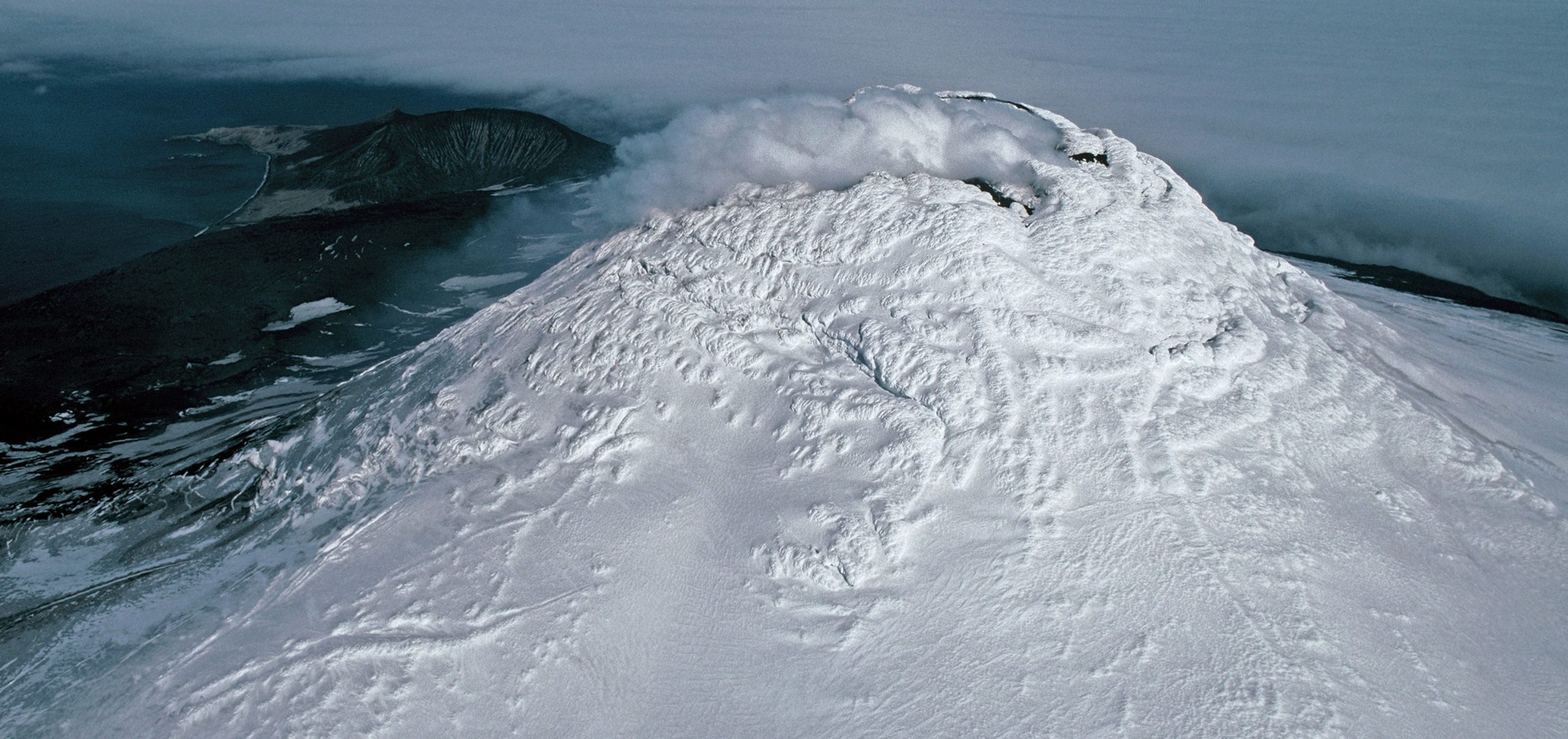 A close up of a snow covered mountain.