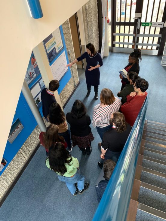 A group of people sitting on a bench.