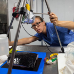 A person that is standing in the kitchen.