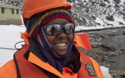 A woman wearing bright orange cold weather clothing