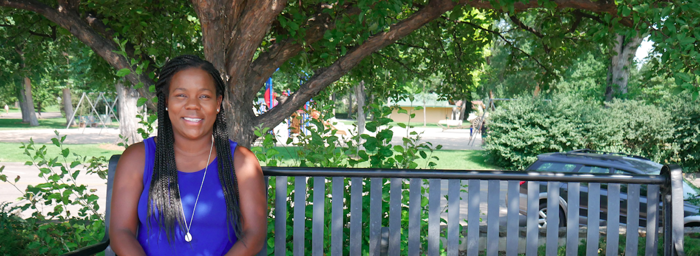 Black female scientist Melissa Burt sitting on a park bench
