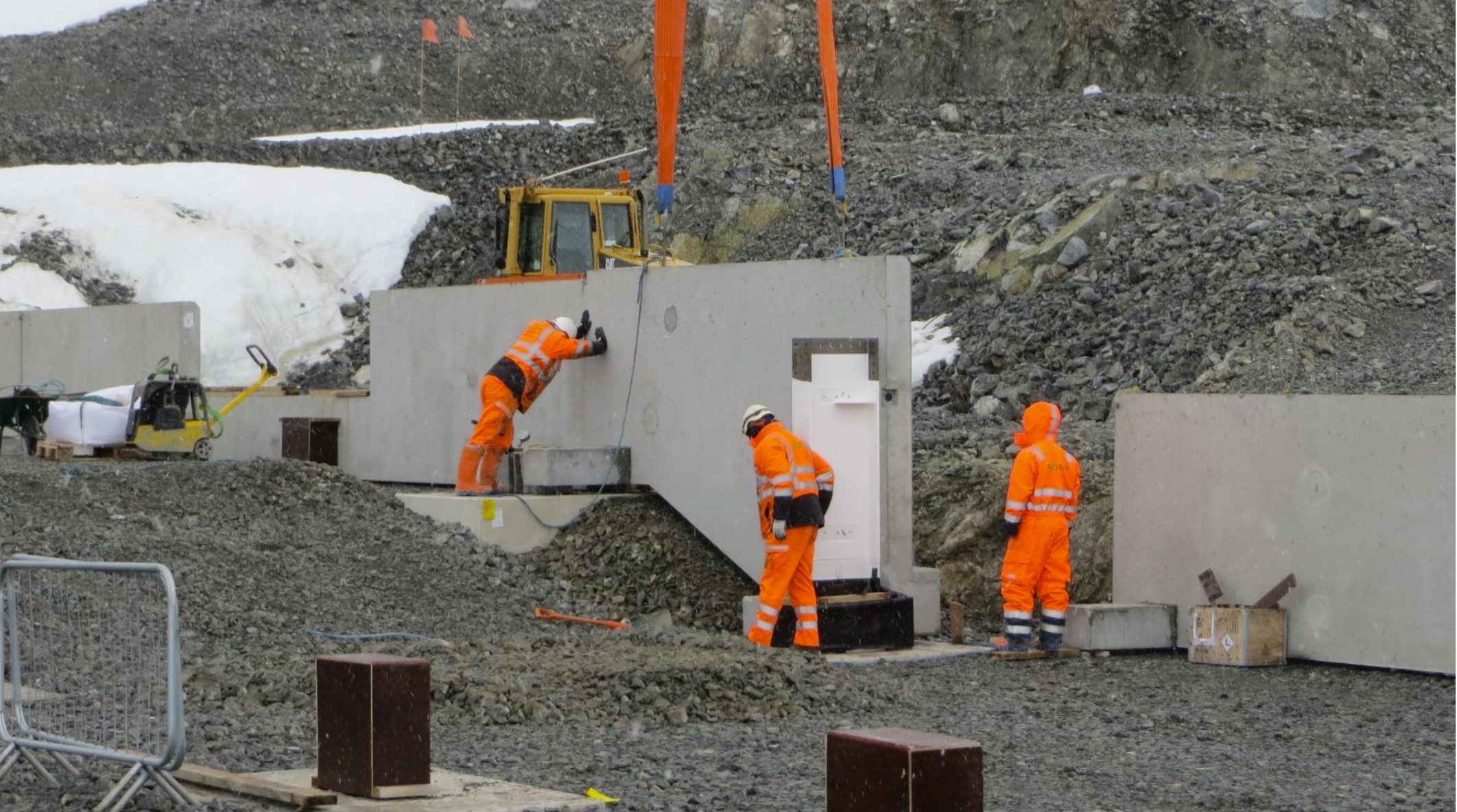 Construction worker installing concrete wall