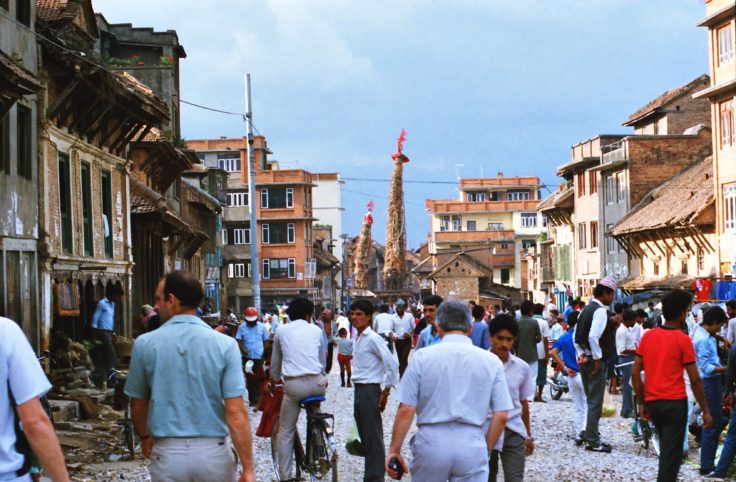 A group of people walking on a city street