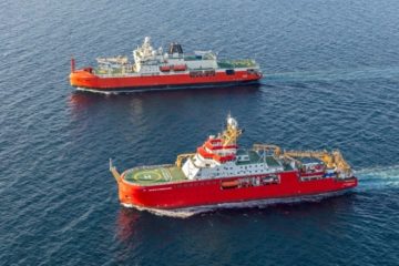 Two large red research ships in the ocean