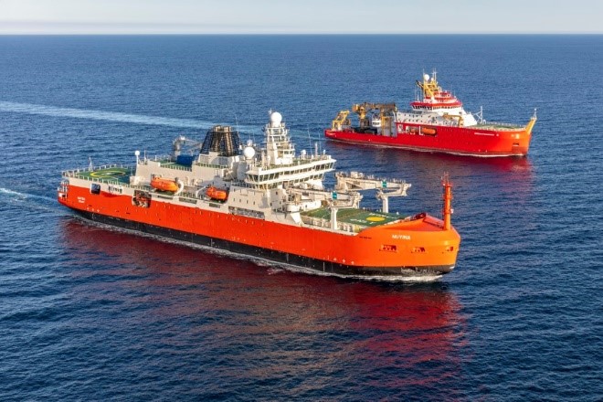 Two large red research ships in the ocean