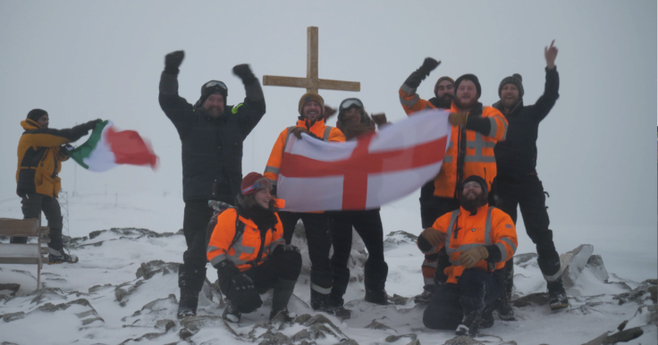 A group of people posing for a picture in the snow