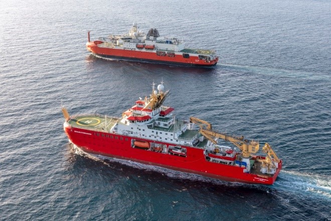 Two large red research ships in the ocean