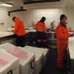 Three people in a cold laboratory.