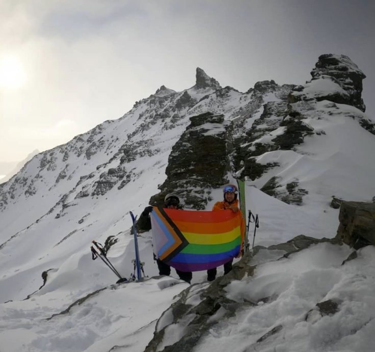 A man riding skis down a snow covered mountain