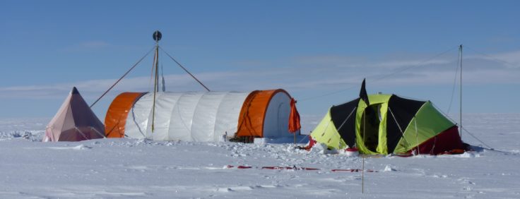 A man flying a kite in the snow