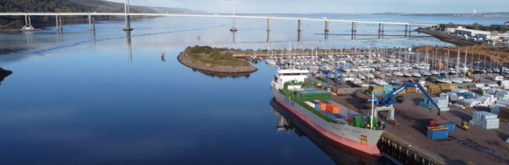 A boat is docked next to a body of water