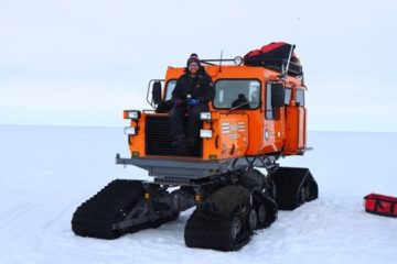 Author of this blog, Neil Brims, sits on an orange vehicle at Halley 