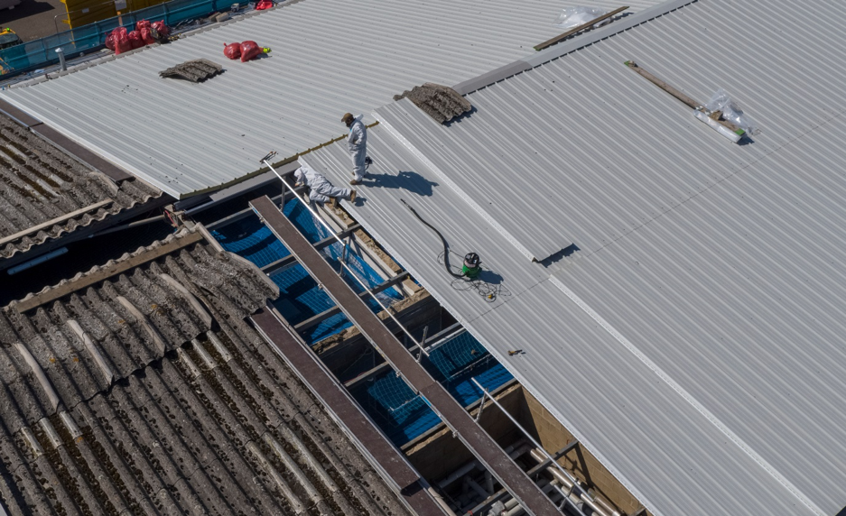 The roof of a building with people working on it