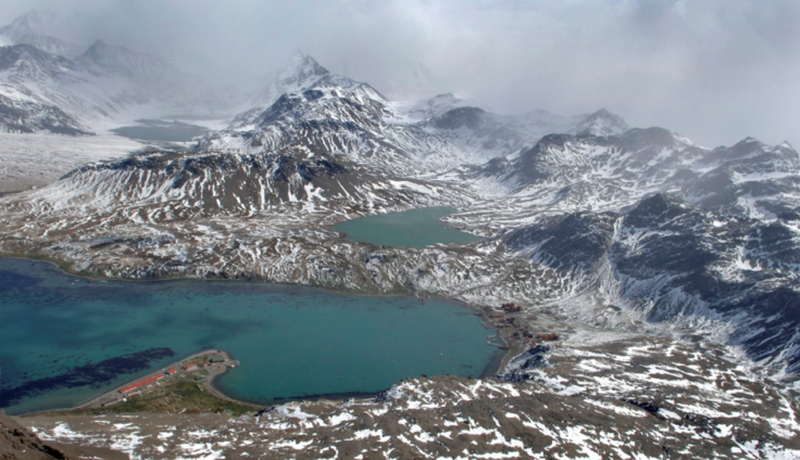 An areal image of a snow covered mountain