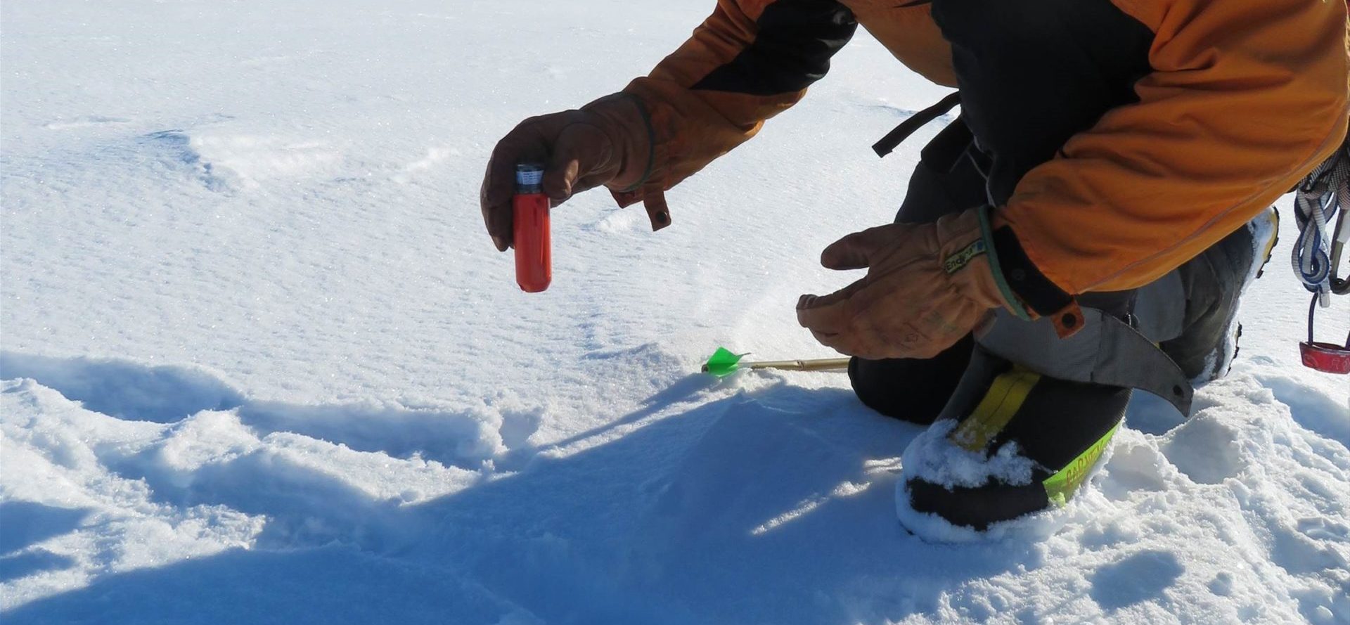 A person standing on a snow covered slope