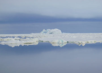 A group of clouds in the sky over a body of water