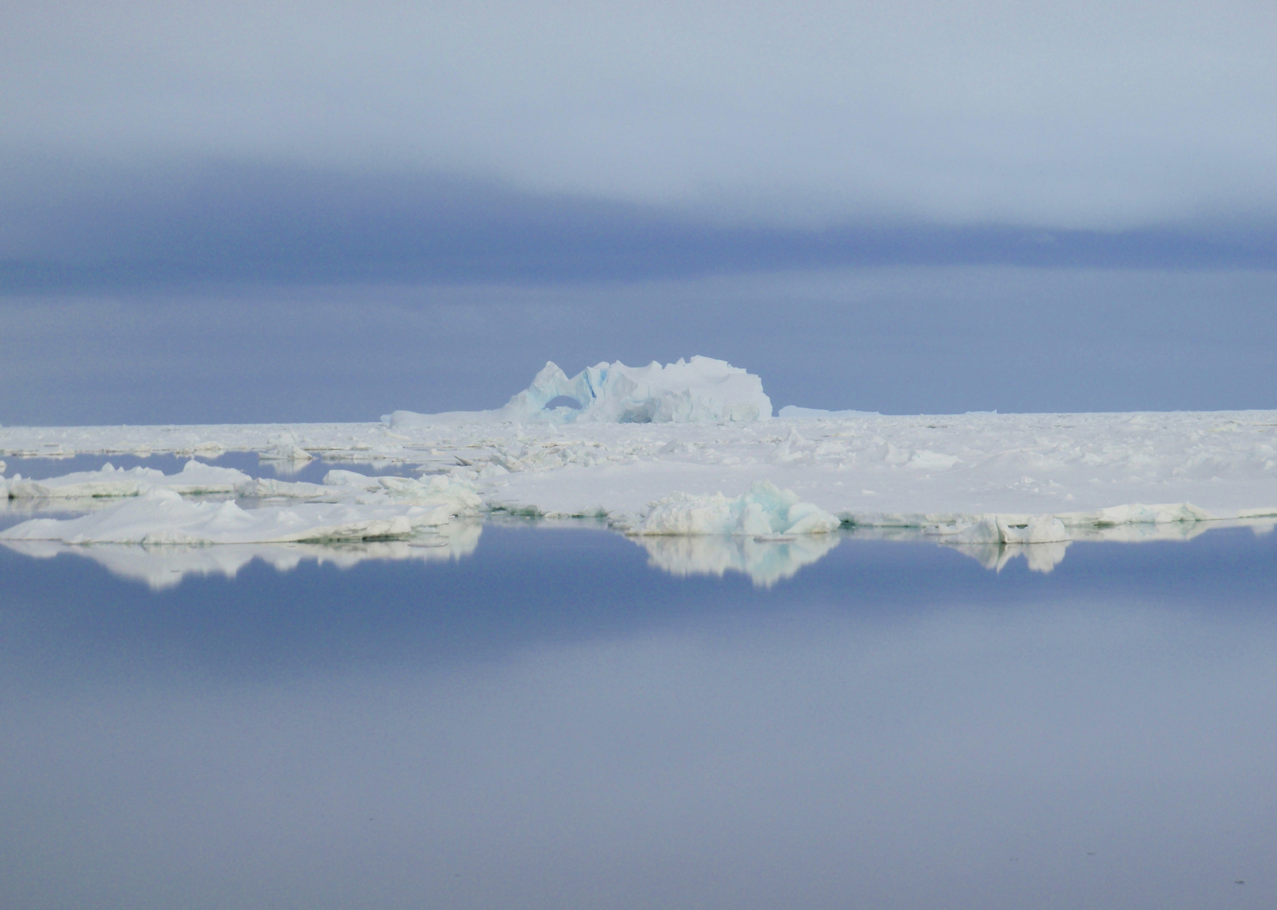 A group of clouds in the sky over a body of water