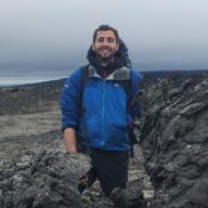 A man standing on a rocky hill