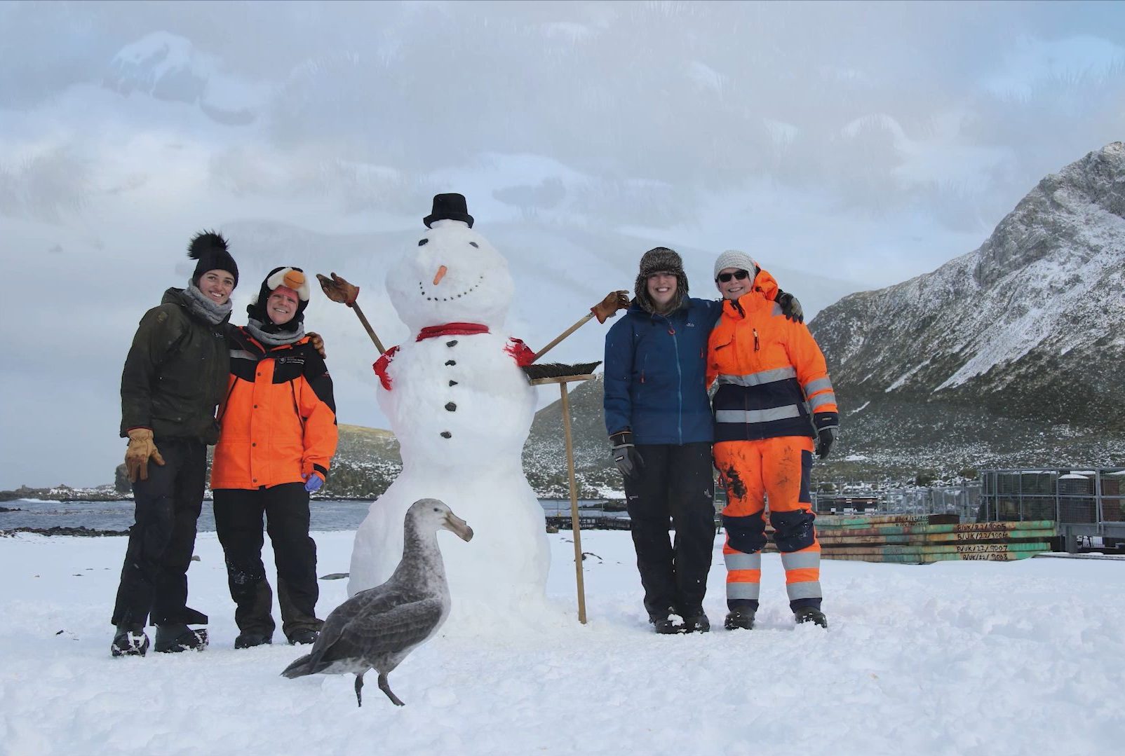 A couple of people that are standing in the snow