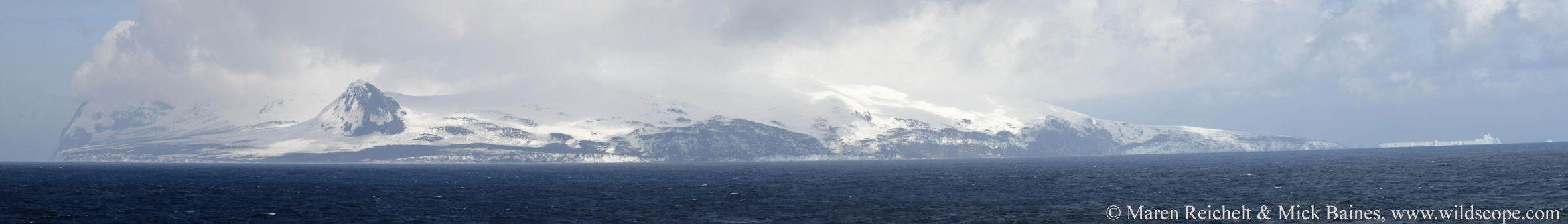 A large body of water with a mountain in the background