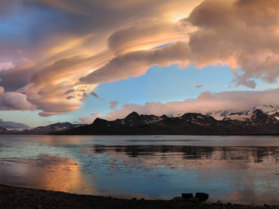 A group of clouds in the sky on a beach