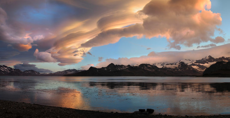 A group of clouds in the sky on a beach