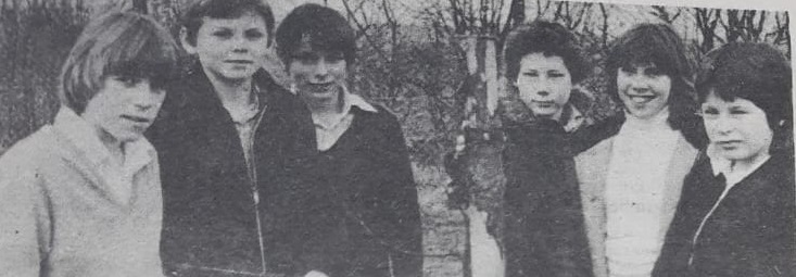 A vintage photo of a group of people posing for the camera