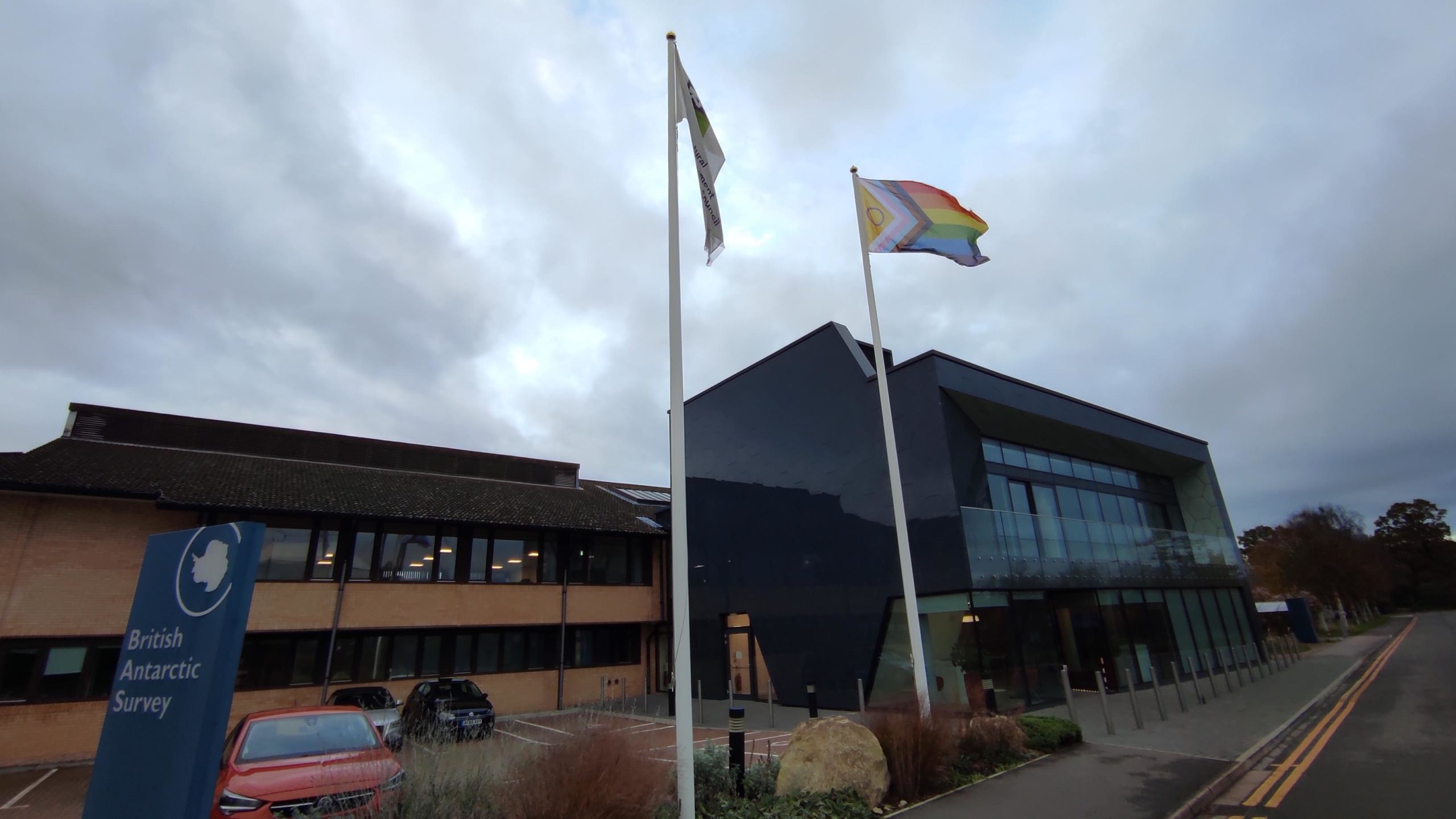 A flag and a sign in front of a building