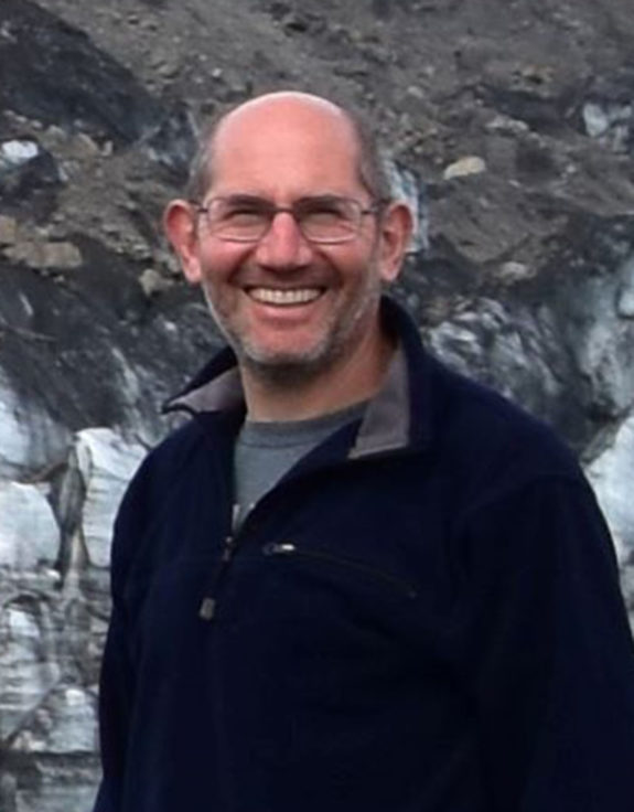 A man standing in front of a mountain