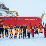 SDA crew celebrate successful trials on the sea ice in front of the ship