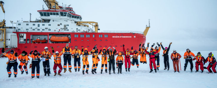 SDA crew celebrate successful trials on the sea ice in front of the ship 