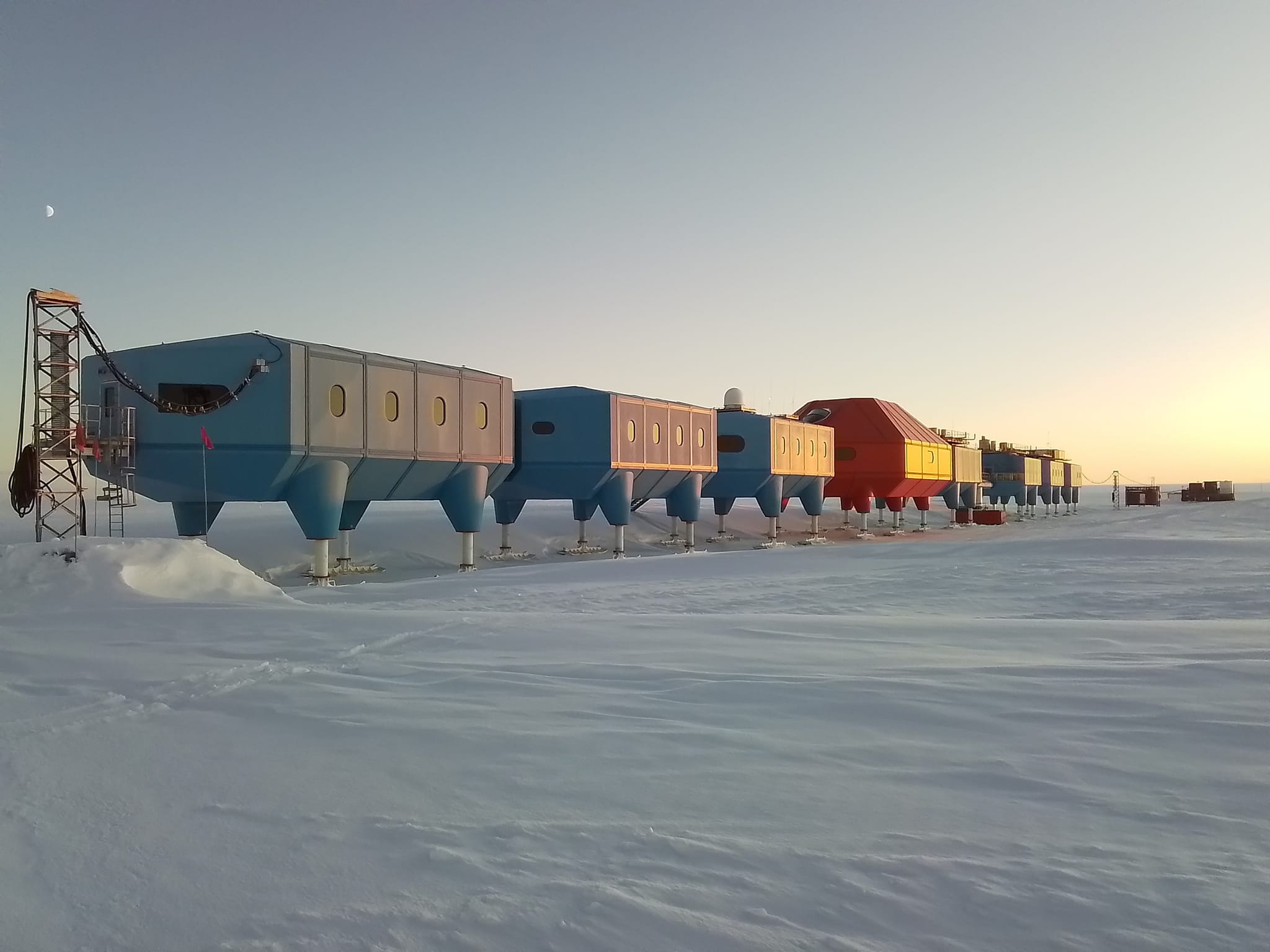 a group of futuristic buildings in the snow