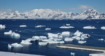 A large ship in the snow with a mountain in the background