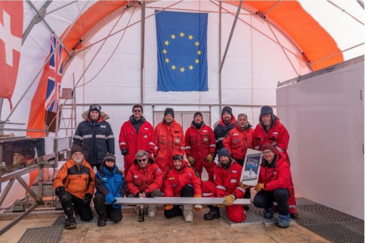 A group of people standing in front of a tent