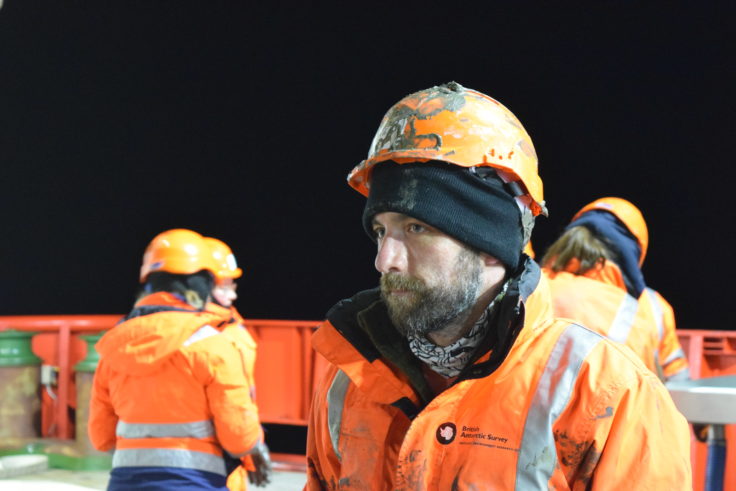 One of the authors of the blog, Jamie Campbell, is photographed at night, wearing muddy high visibility gear and a warm hat. 