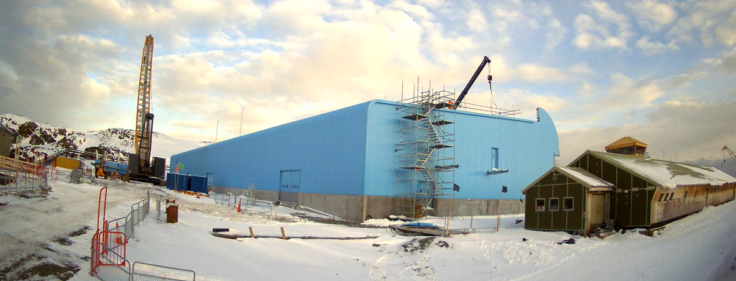 A large blue building in the snow